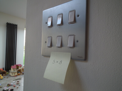 a times table post-it on a light switch