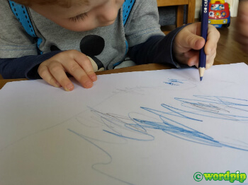 child holding blue pencil correctly tripod grip