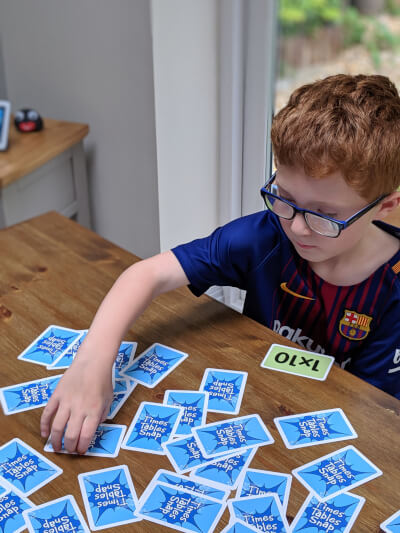 A boy playing times table snap game