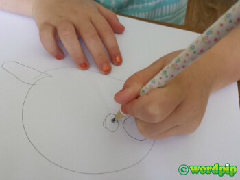 photo of a child drawing using a tripod grip