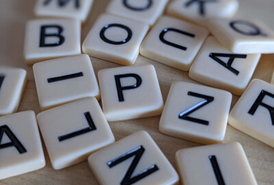 scrabble letters scattered on a wooden table